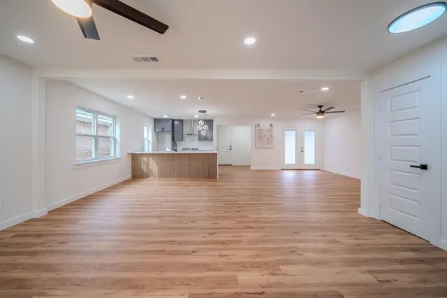 a view of kitchen and hall with wooden floor