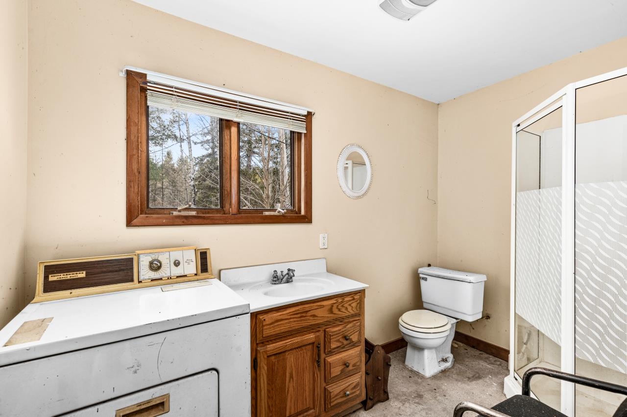 2040 Green Acres Road Maple, WI 54854 - Photo 11 of 19 Full bath with washer / clothes dryer, vanity, and a shower stall