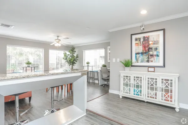 a living room with furniture a large window and wooden floor