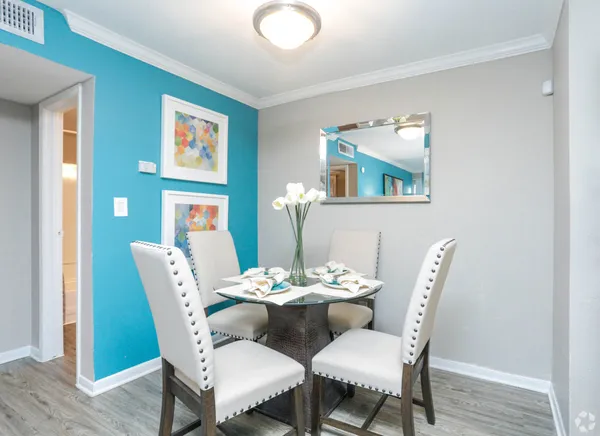 a dining room with furniture and wooden floor