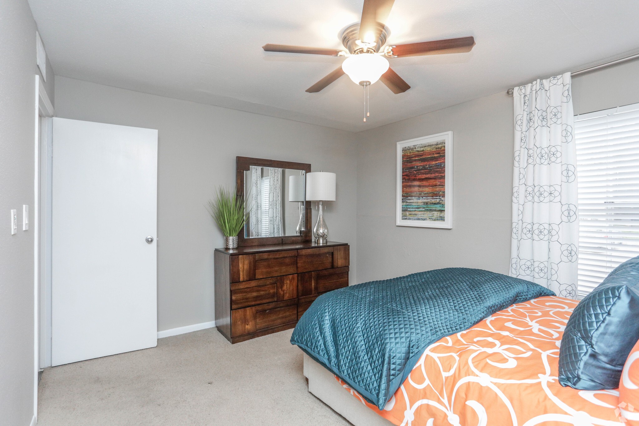 10250 Lands End Drive, Unit 1010 Houston, TX 77099 - Photo 16 of 27 a bedroom with a bed and a chandelier