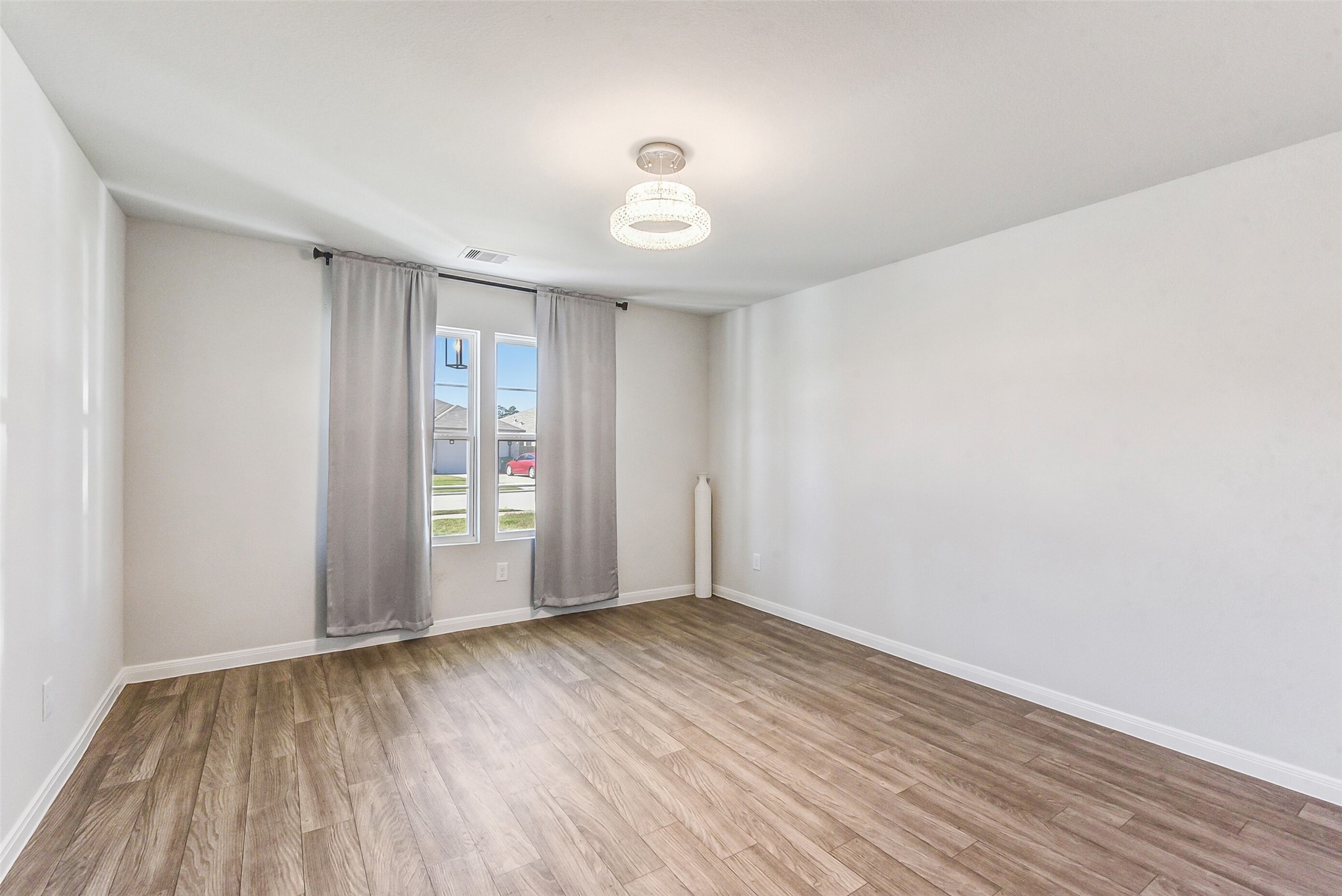 20142 Torrey Pines Lane Cleveland, TX 77327 - Photo 14 of 42 a view of an empty room with wooden floor and a window
