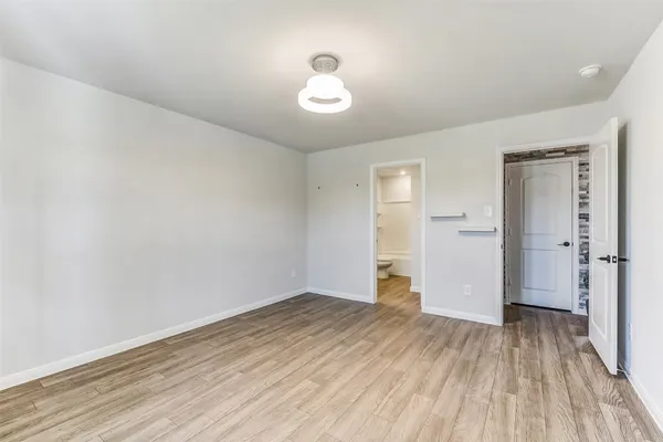 a view of a room with wooden floor and a sink