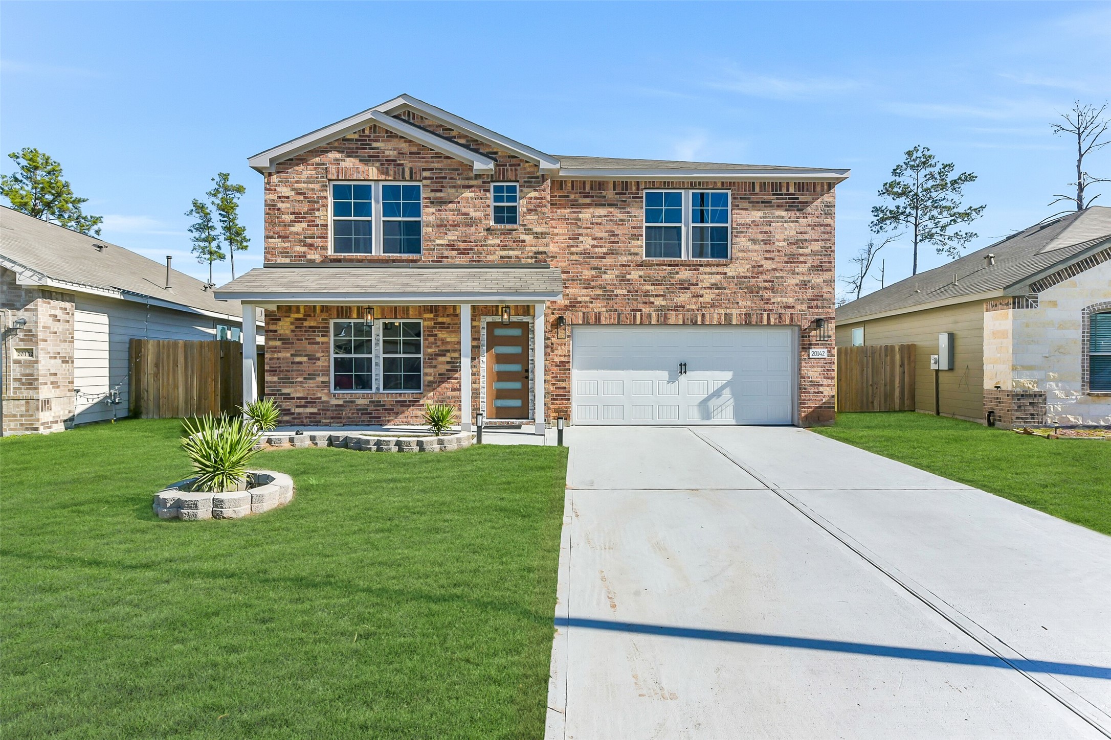 20142 Torrey Pines Lane Cleveland, TX 77327 - Photo 36 of 42 a front view of a house with a yard and trees
