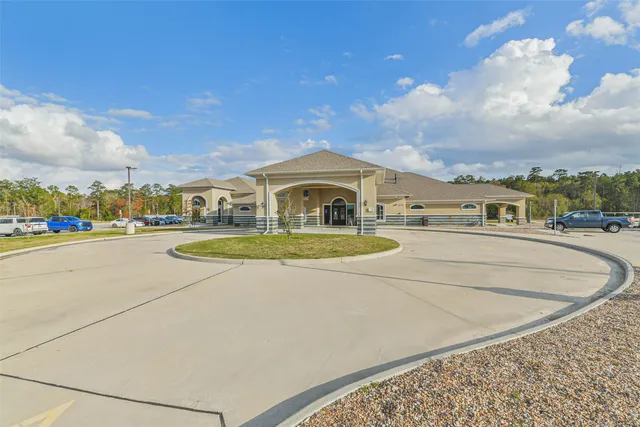 a view of swimming pool with outdoor seating and buildings in the background
