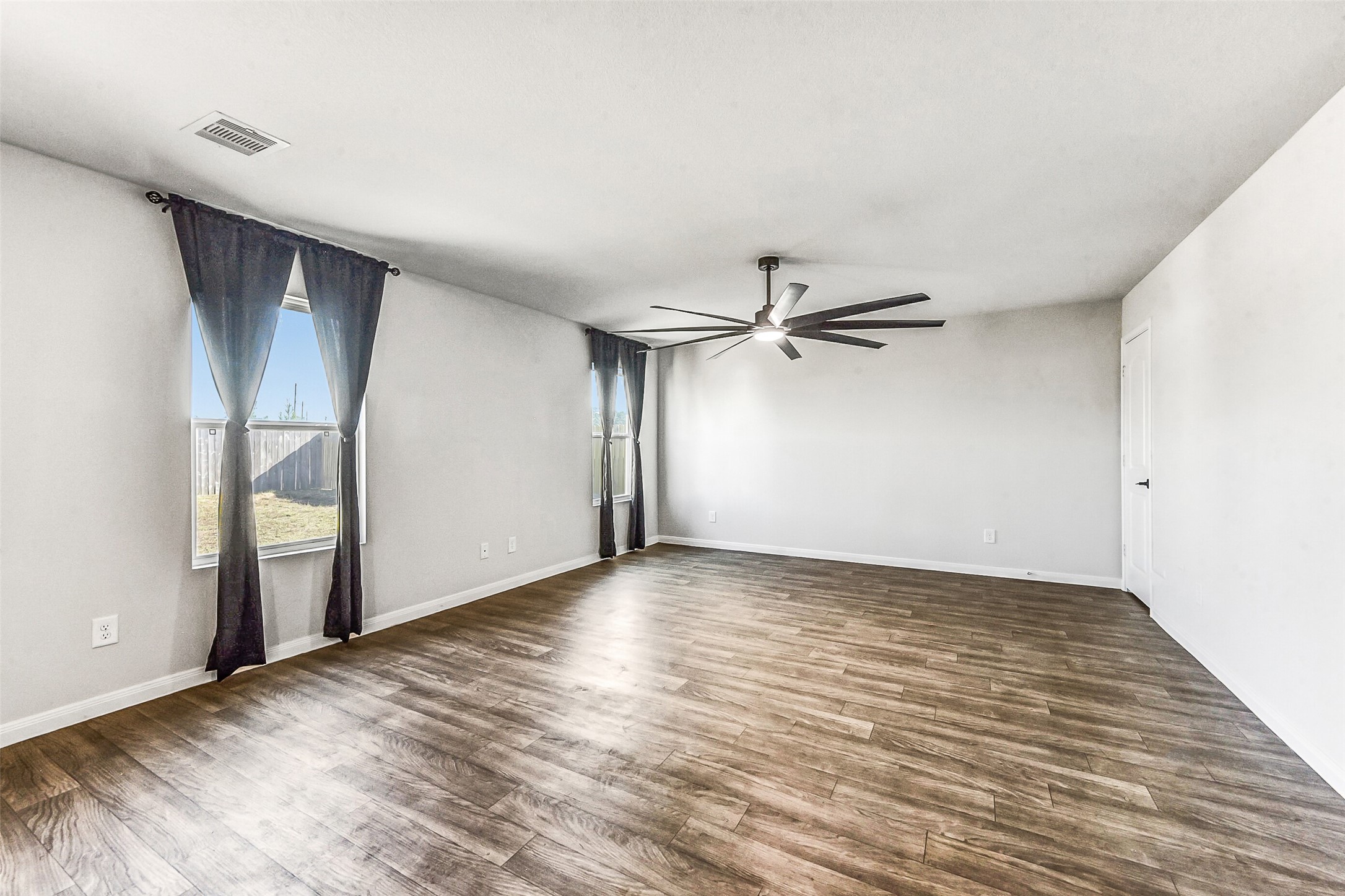 20142 Torrey Pines Lane Cleveland, TX 77327 - Photo 10 of 42 an empty room with wooden floor closet and windows