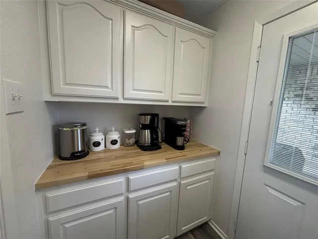 a kitchen with white cabinets and white appliances