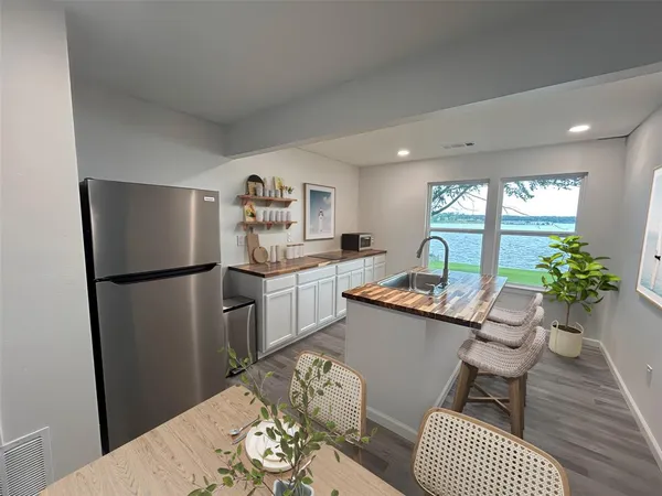 a kitchen with granite countertop a refrigerator and a sink