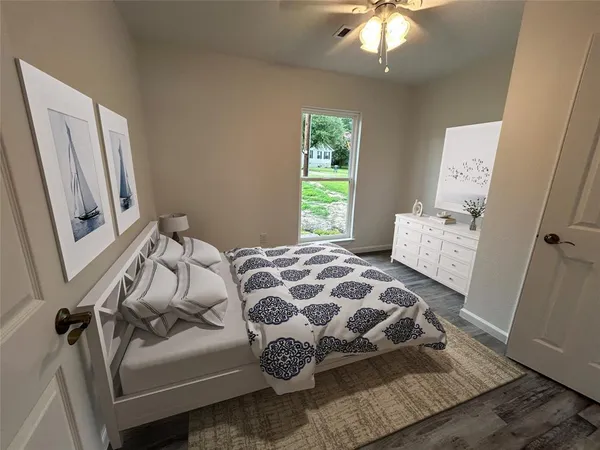 a bedroom with a bed and a window