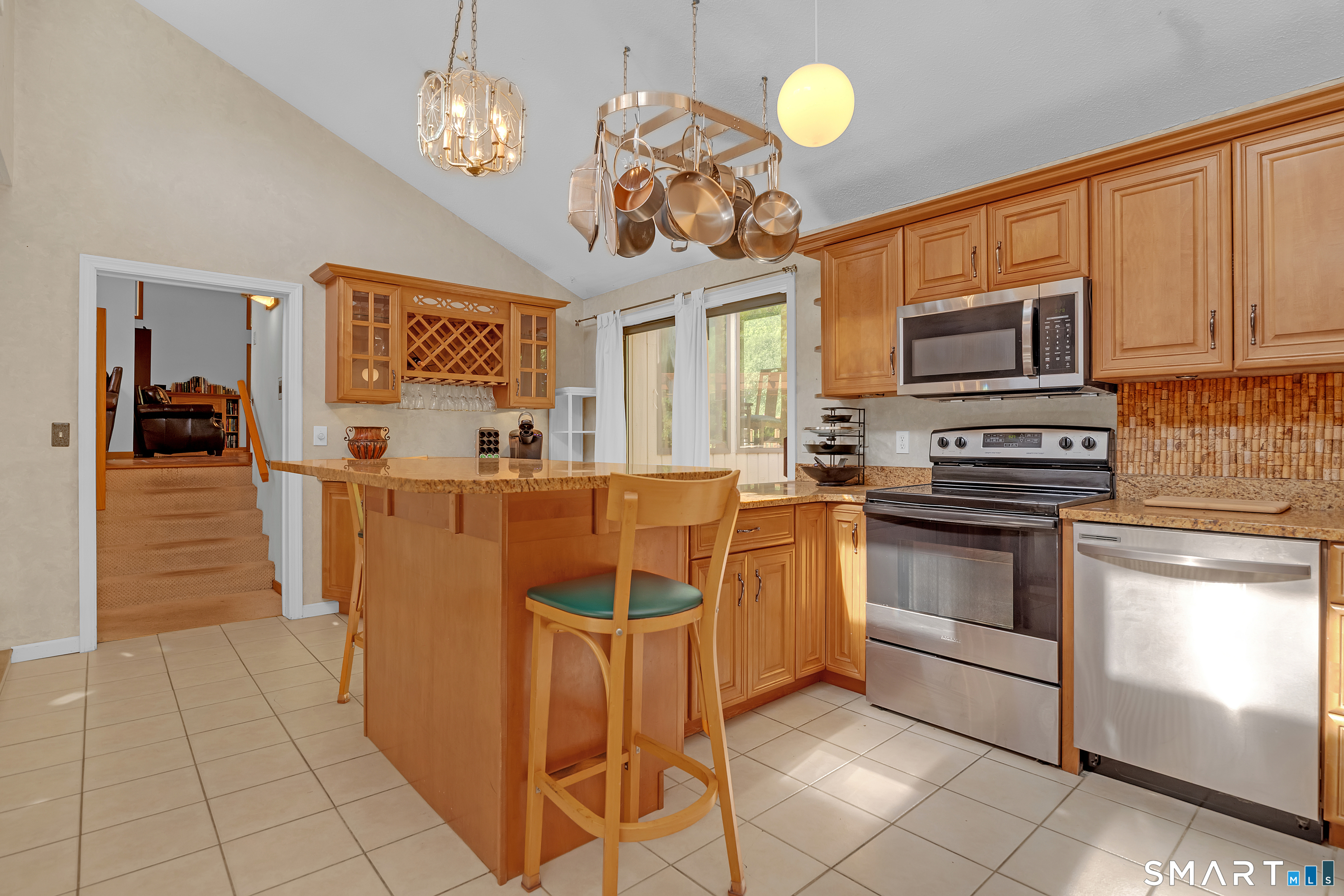 90 Bell Street Manchester, CT 06040 - Photo 4 of 40 a kitchen with stainless steel appliances granite countertop a stove top oven a sink dishwasher and a refrigerator with wooden cabinets