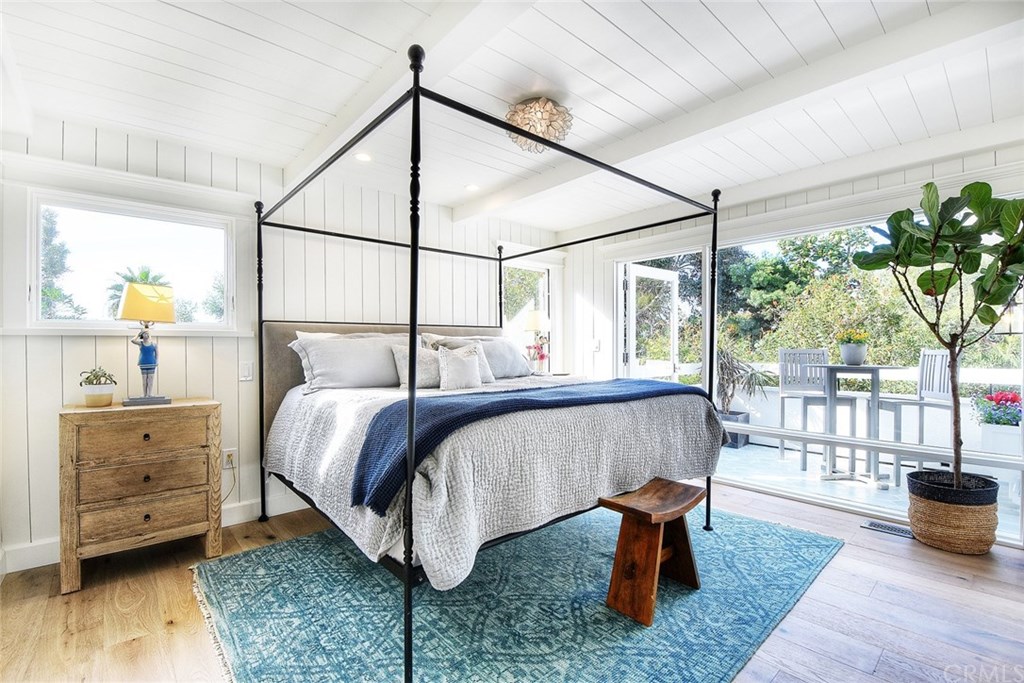 564 Oak Street Laguna Beach, CA 92651 - Photo 15 of 34 Gorgeous master suite with a wall of windows and private balcony with handmade tile flooring overlooking the trees and backyard.