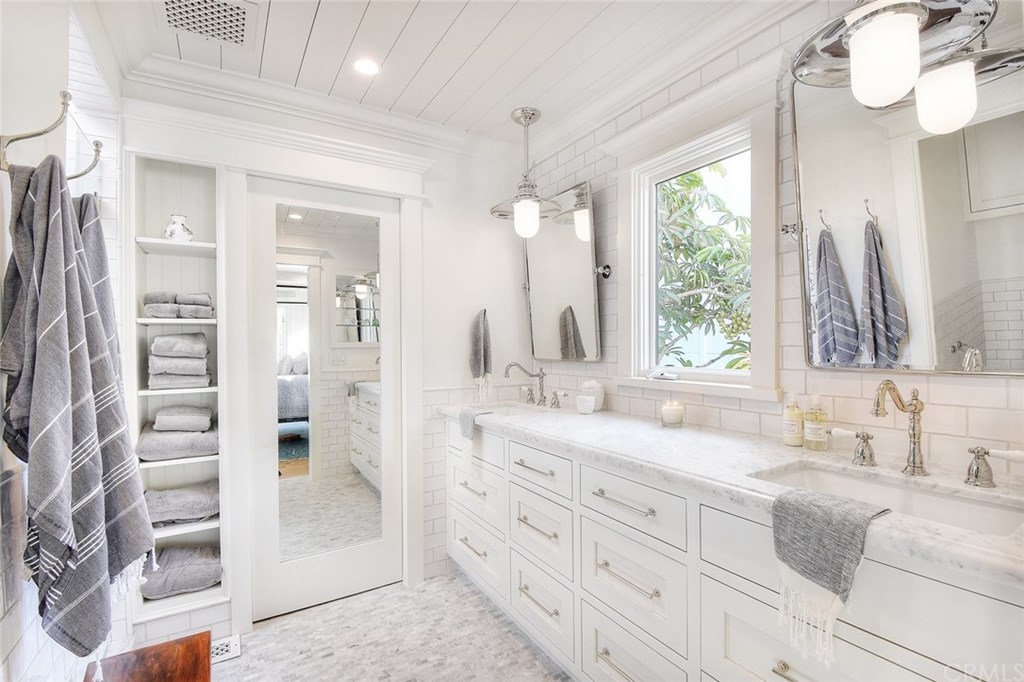 564 Oak Street Laguna Beach, CA 92651 - Photo 17 of 34 No detail was overlooked in this luxurious master bath. The mirrored pocket door leads to a large custom walk-in closet.
