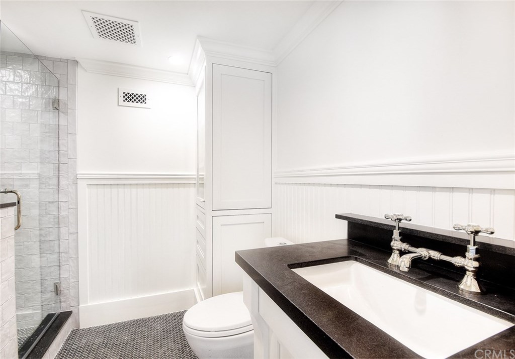 564 Oak Street Laguna Beach, CA 92651 - Photo 26 of 34 Gorgeous bath off bonus room with built-ins and Basalt tile flooring.