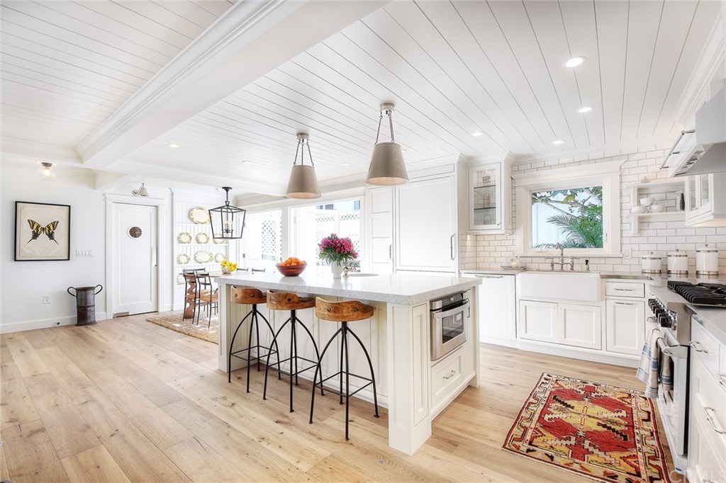 564 Oak Street Laguna Beach, CA 92651 - Photo 6 of 34 This gourmet kitchen also boasts custom soft-close cabinets, handmade porcelain tile backsplash, polished nickel drawer pulls, and a farmhouse sink.