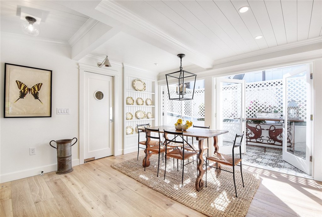 564 Oak Street Laguna Beach, CA 92651 - Photo 7 of 34 The kitchen flows effortlessly into the spacious dining room, perfect for entertaining. French doors lead to a sunny and private patio with stunning handmade tile flooring, while the swinging door leads to a powder room, laundry room, and garage.