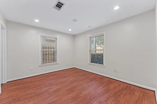 wooden floor in an empty room with a window