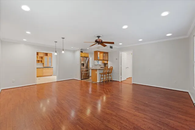 a view of a kitchen with furniture and wooden floor