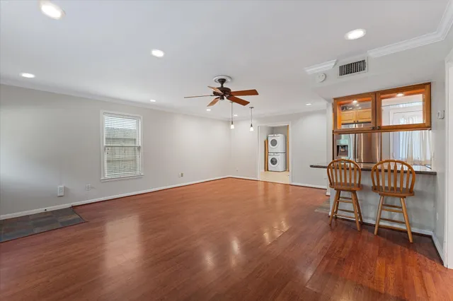 a furnished livingroom with windows and wooden floor