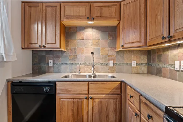 a kitchen with stainless steel appliances granite countertop a sink stove and cabinets