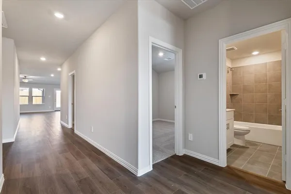 a an empty room and a bathroom with toilet