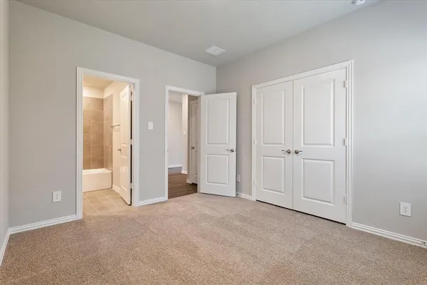a view of an empty room and closet area