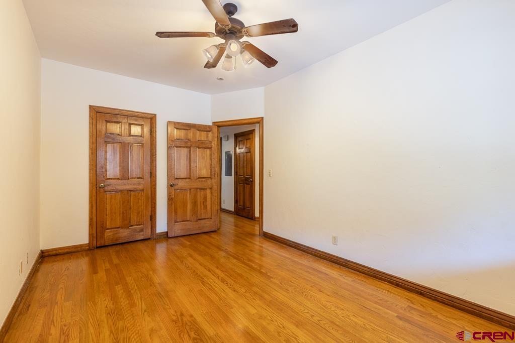 355 East 3rd Avenue, Unit 112 Durango, CO 81301 - Photo 14 of 27 an empty room with wooden floor closet and windows
