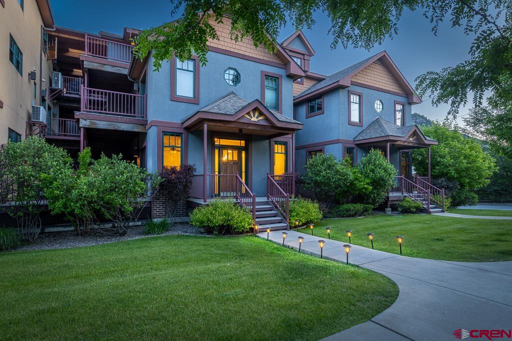 355 East 3rd Avenue, Unit 112 Durango, CO 81301 - Photo 2 of 27 a front view of a house with a yard