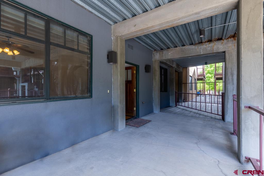 355 East 3rd Avenue, Unit 112 Durango, CO 81301 - Photo 21 of 27 a view of a hallway with wooden staircase