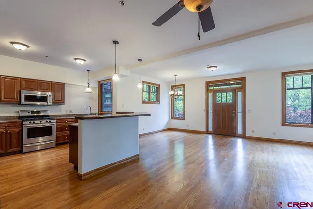 a view of kitchen with sink and refrigerator