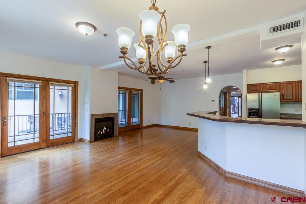 355 East 3rd Avenue, Unit 112 Durango, CO 81301 - Photo 4 of 27 a kitchen with stainless steel appliances granite countertop a stove and a wooden floors