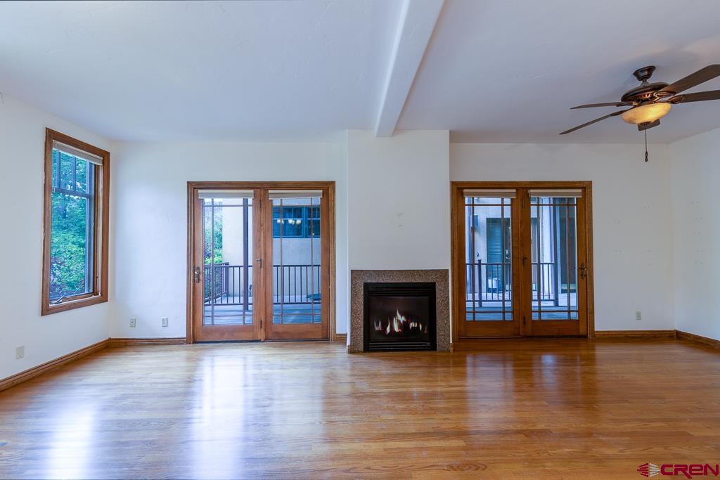 355 East 3rd Avenue, Unit 112 Durango, CO 81301 - Photo 5 of 27 a view of an empty room with window and fire place