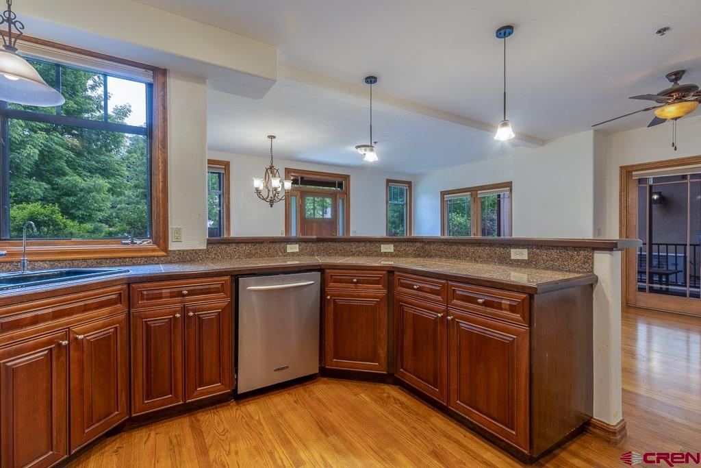 355 East 3rd Avenue, Unit 112 Durango, CO 81301 - Photo 9 of 27 a kitchen with stainless steel appliances granite countertop a sink a stove and a wooden floors
