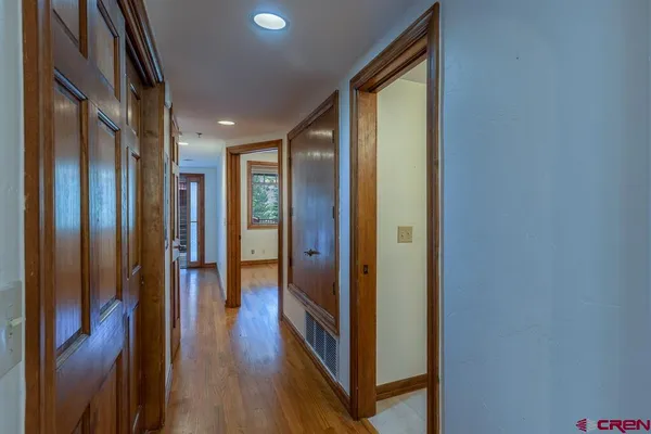 a view of an empty room with wooden floor