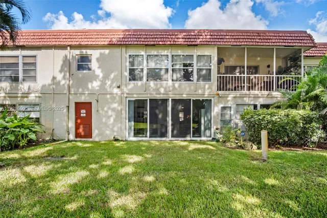 front view of a brick building with a yard