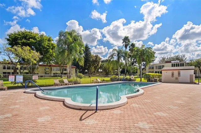 a view of a swimming pool with a lounge chairs
