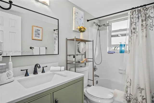 a bathroom with a sink vanity mirror and toilet