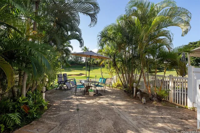 an outdoor space with furniture and umbrella