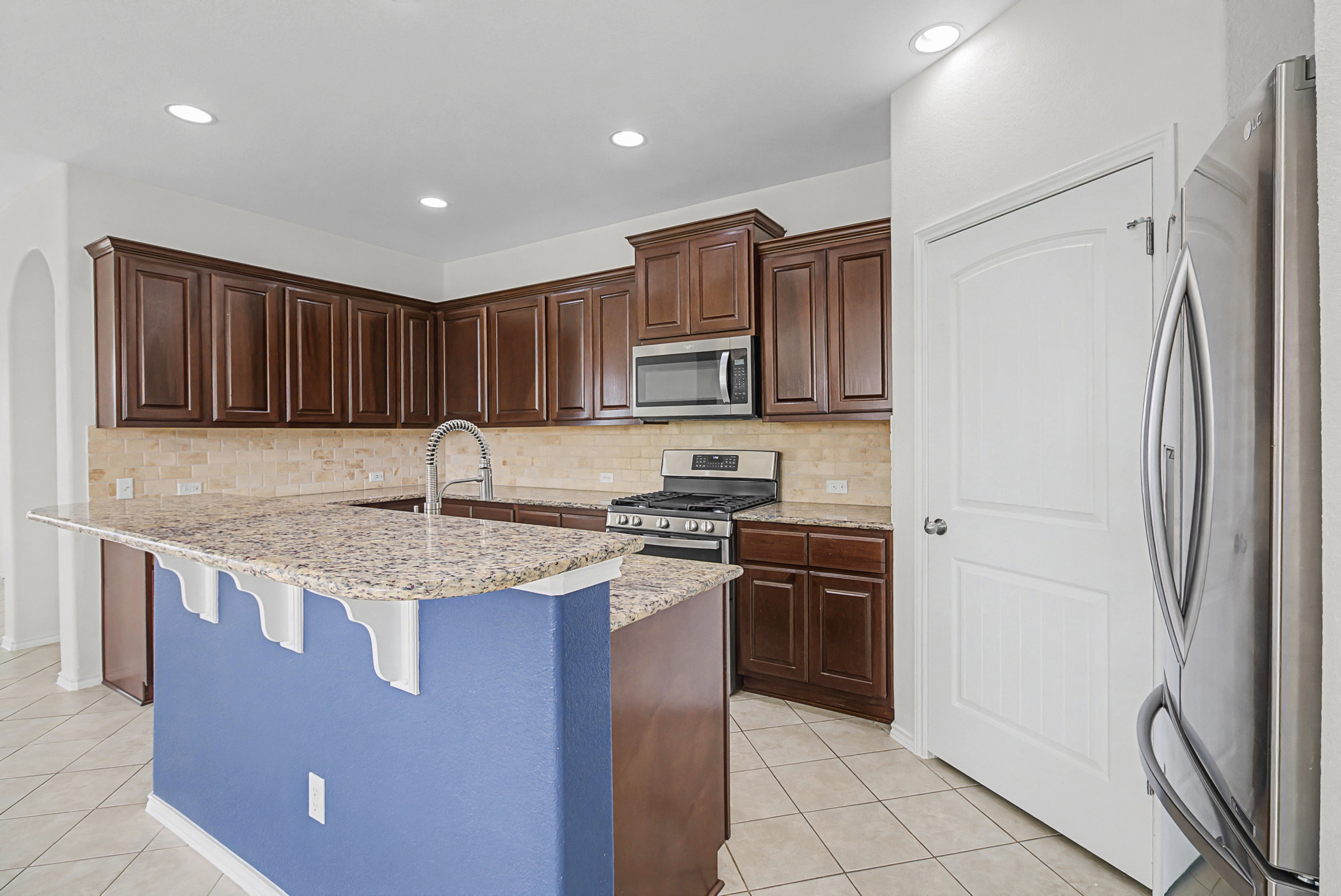 501 Silver Trail Round Rock, TX 78664 - Photo 4 of 22 a kitchen with stainless steel appliances granite countertop a refrigerator stove a sink and dishwasher