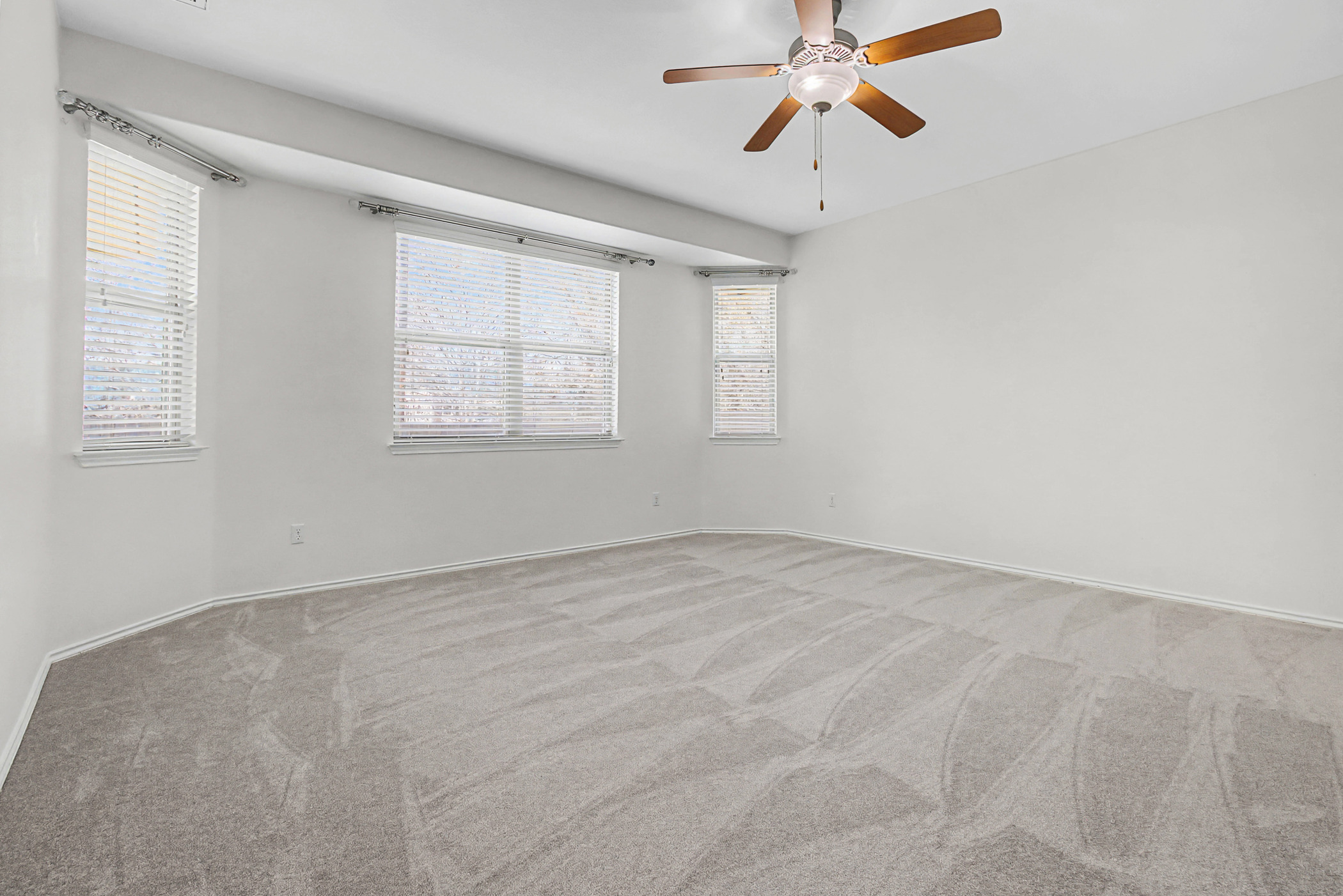 501 Silver Trail Round Rock, TX 78664 - Photo 9 of 22 an empty room with chandelier fan and windows