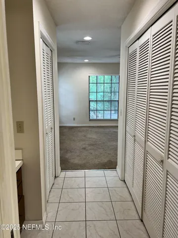 a view of an empty room and a window