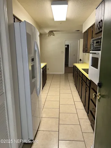 a kitchen with a sink appliances and cabinets