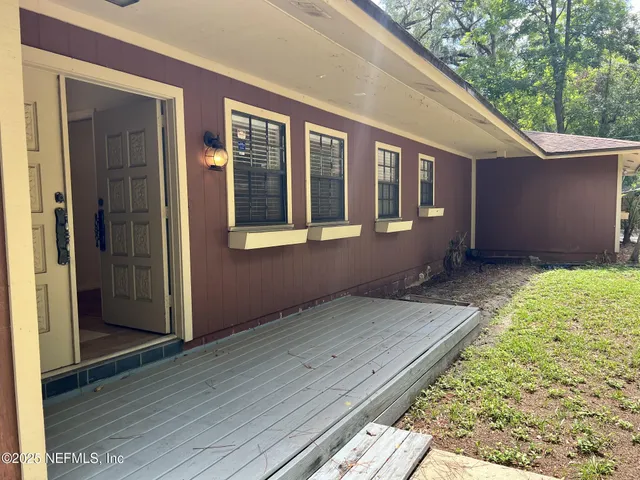 a view of backyard with large windows