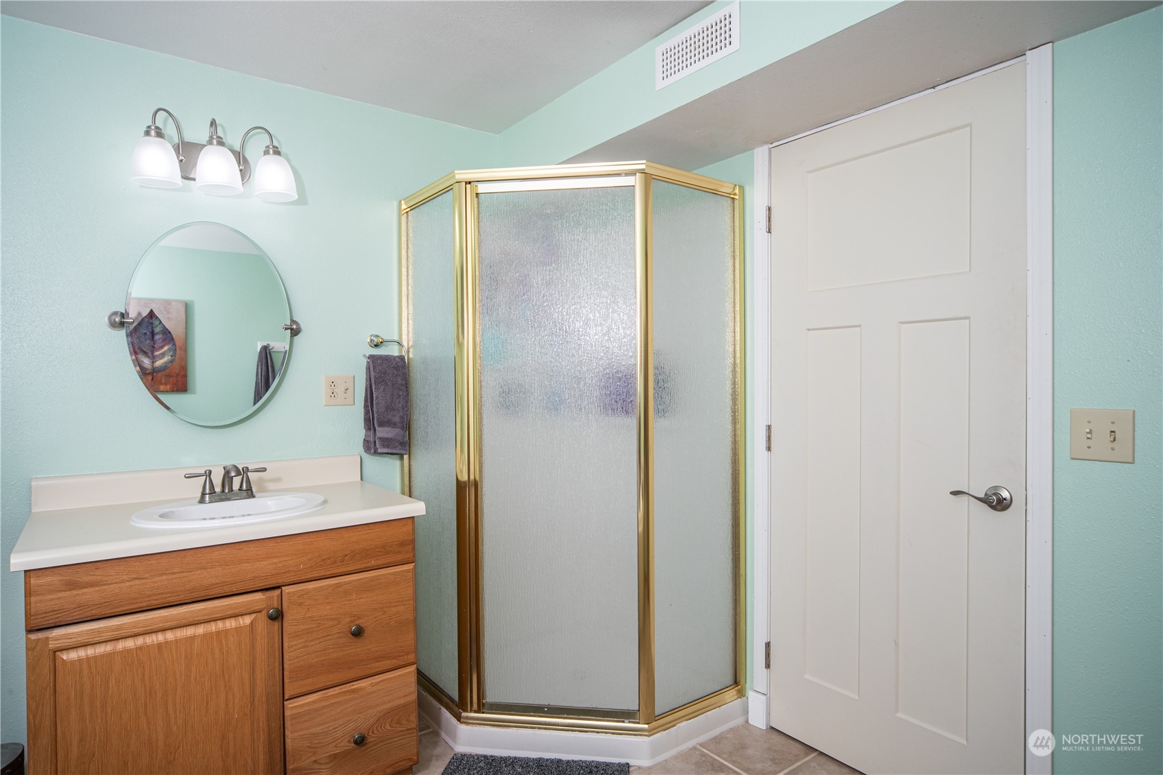 2401 Northeast John Carlson Road Bremerton, WA 98311 - Photo 19 of 36 a bathroom with a mirror sink and mirror