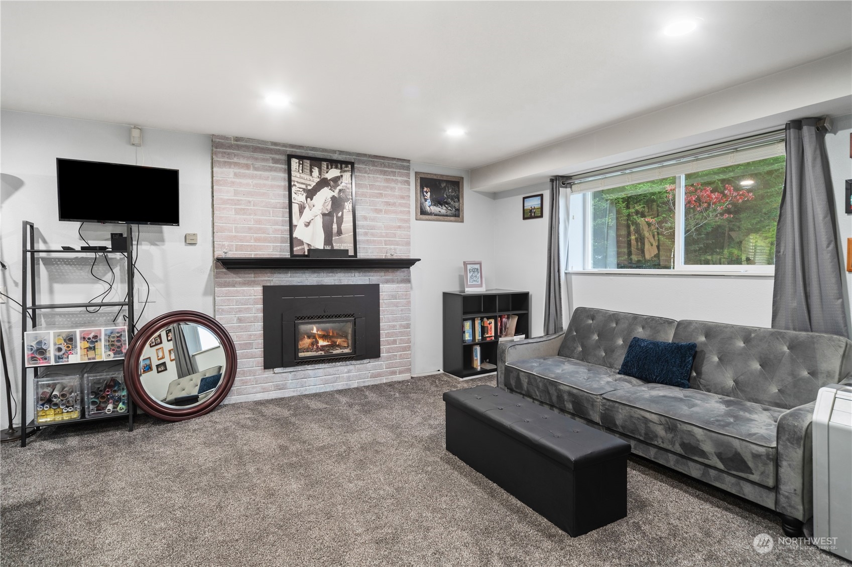 2401 Northeast John Carlson Road Bremerton, WA 98311 - Photo 22 of 36 a living room with furniture a flat screen tv and a fireplace