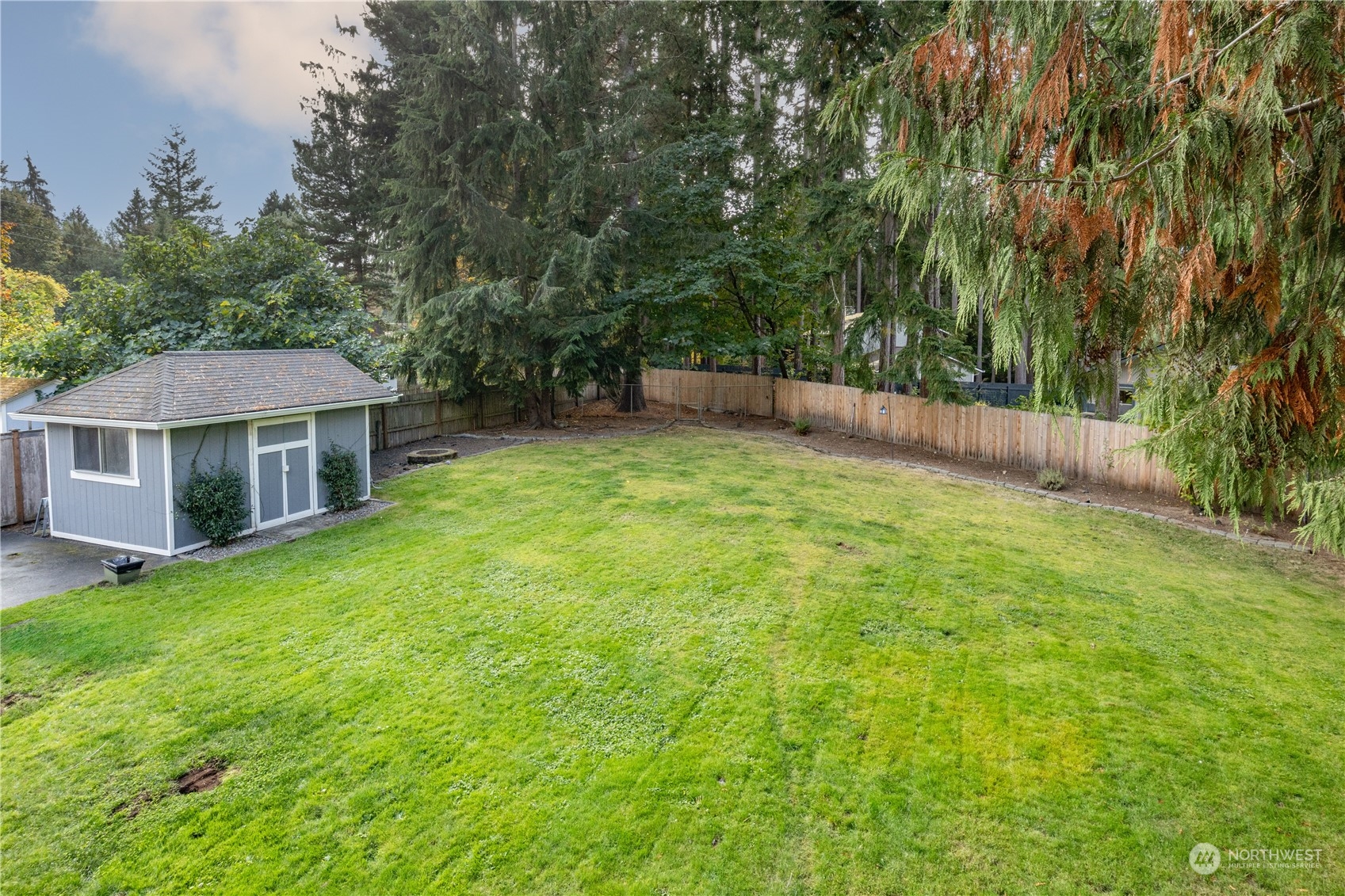 2401 Northeast John Carlson Road Bremerton, WA 98311 - Photo 29 of 36 a backyard of a house with table and chairs