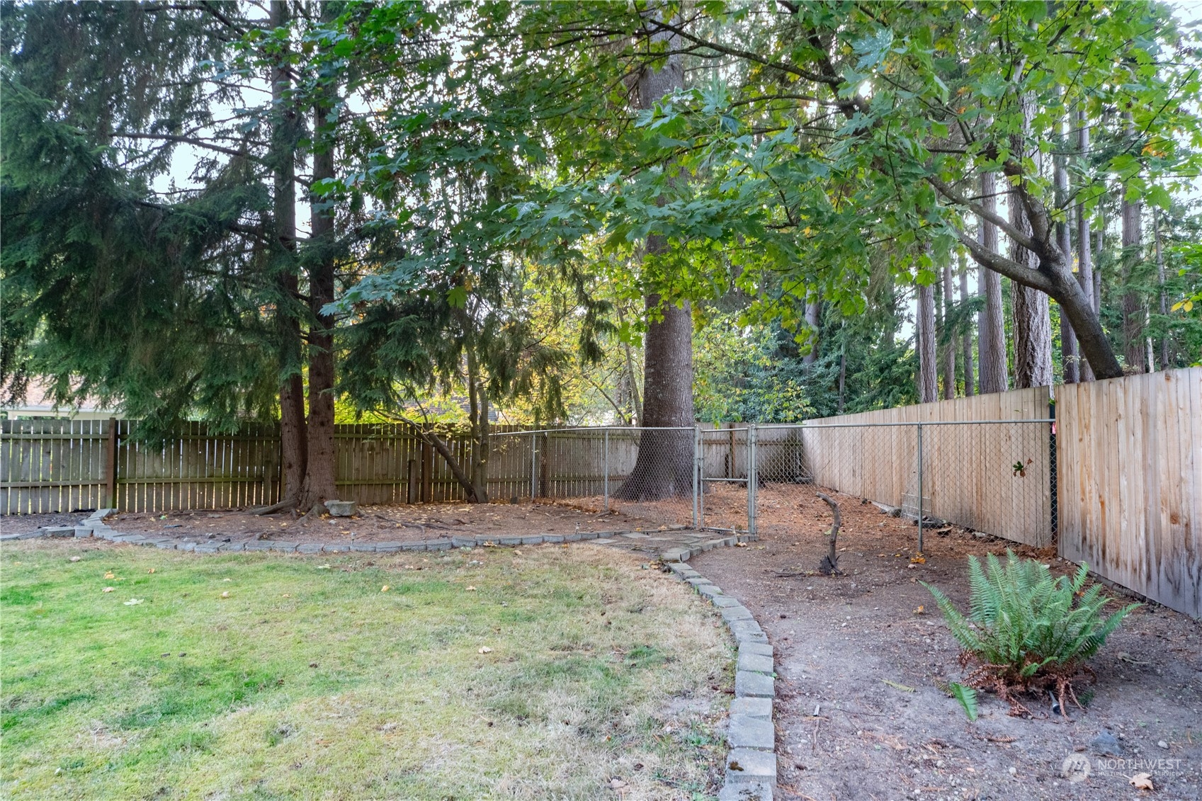 2401 Northeast John Carlson Road Bremerton, WA 98311 - Photo 32 of 36 a backyard of a house with lots of green space