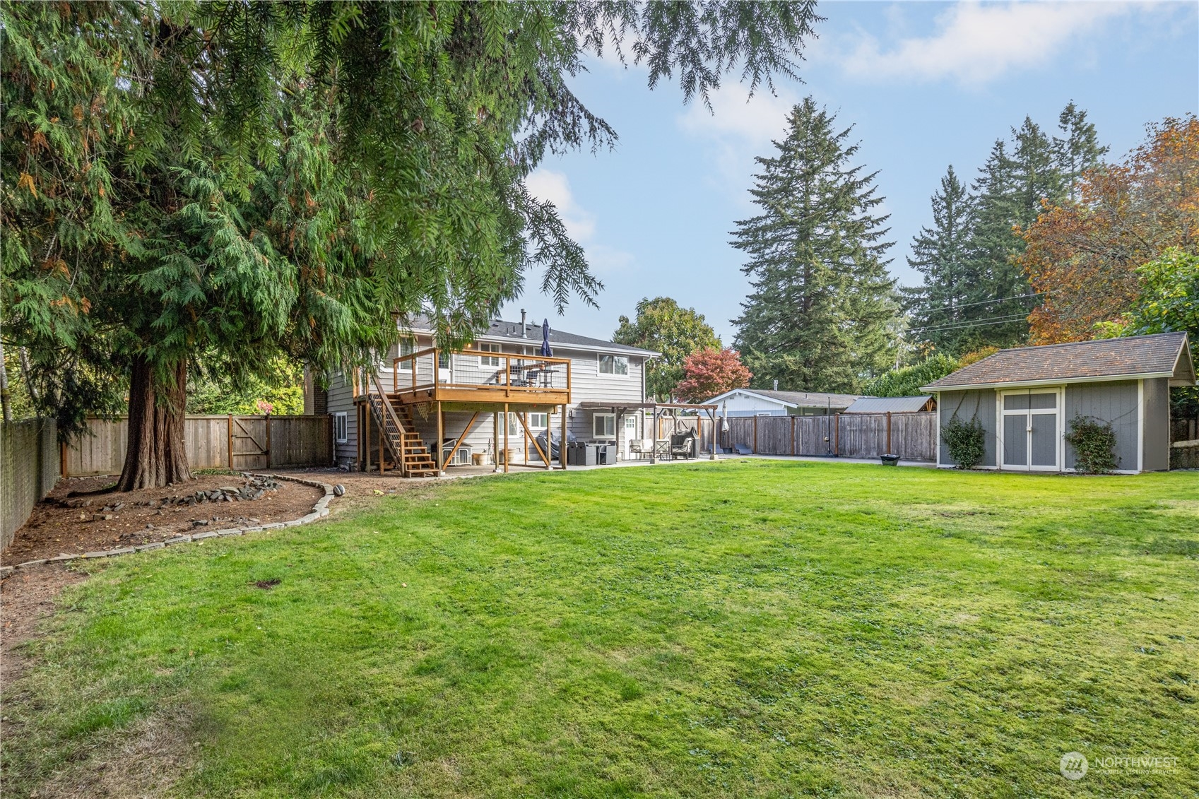 2401 Northeast John Carlson Road Bremerton, WA 98311 - Photo 33 of 36 a front view of a house with a garden and trees