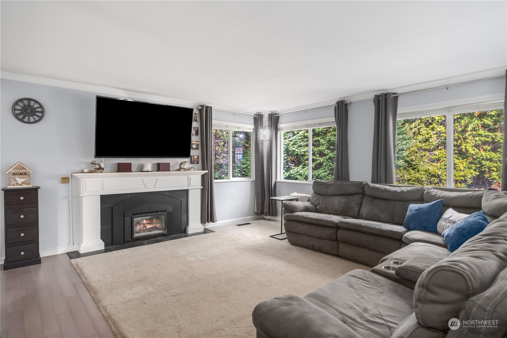 2401 Northeast John Carlson Road Bremerton, WA 98311 - Photo 4 of 36 a living room with furniture a fireplace and a flat screen tv
