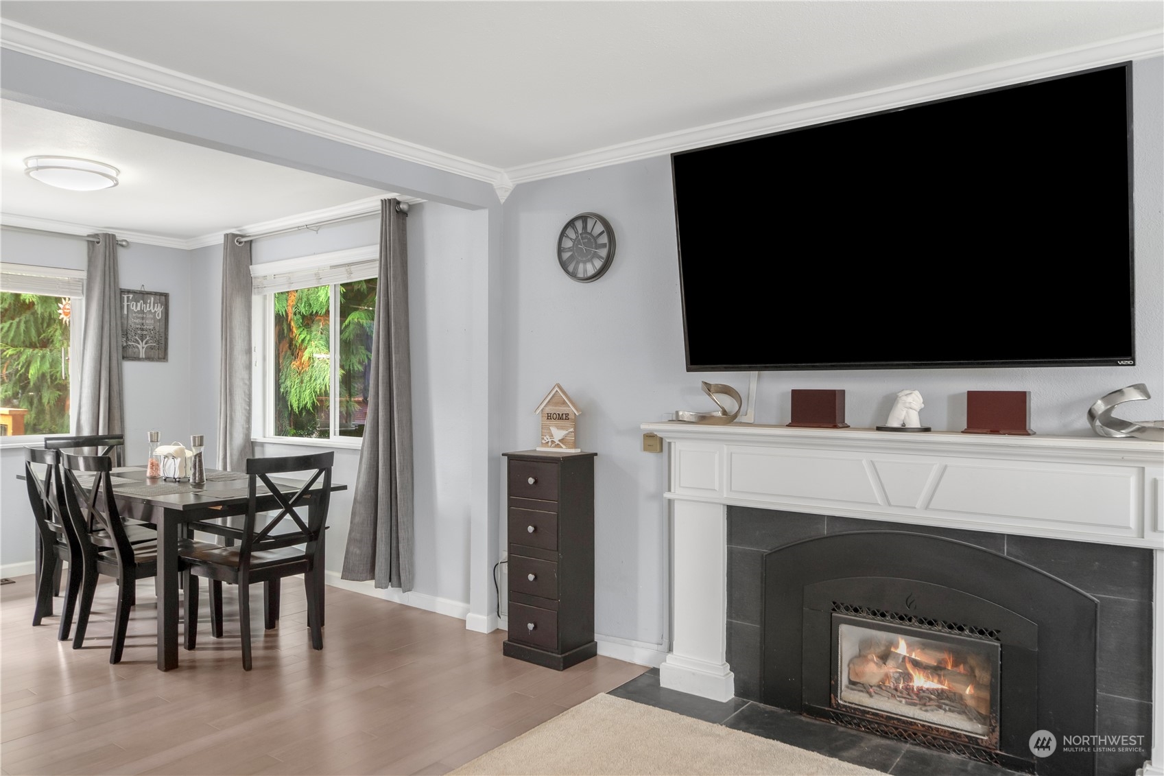 2401 Northeast John Carlson Road Bremerton, WA 98311 - Photo 6 of 36 a living room with furniture a flat screen tv and a fireplace