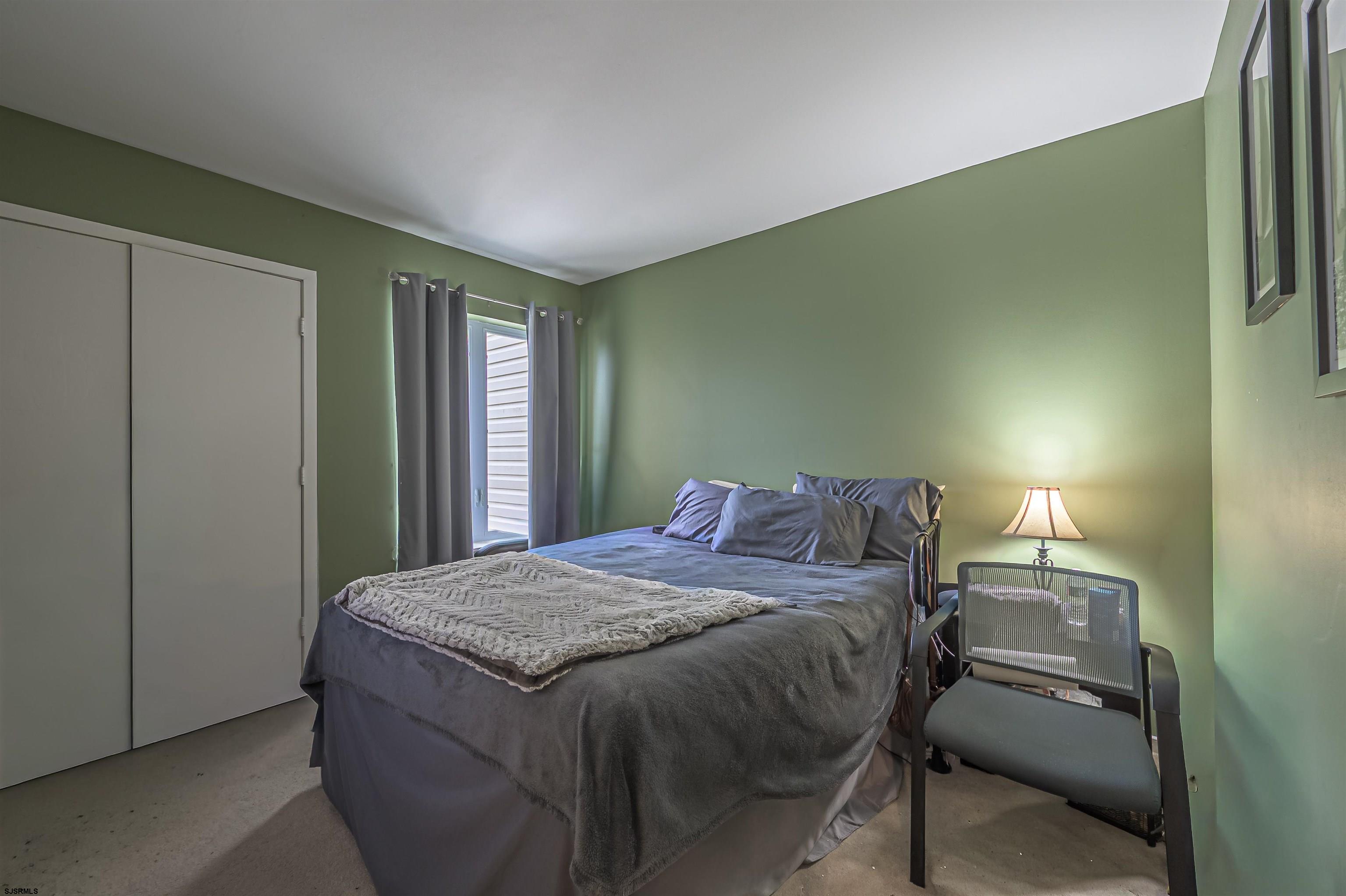 6 Marc Lane Brigantine, NJ 08203 - Photo 20 of 28 a bed sitting in a bedroom next to a window